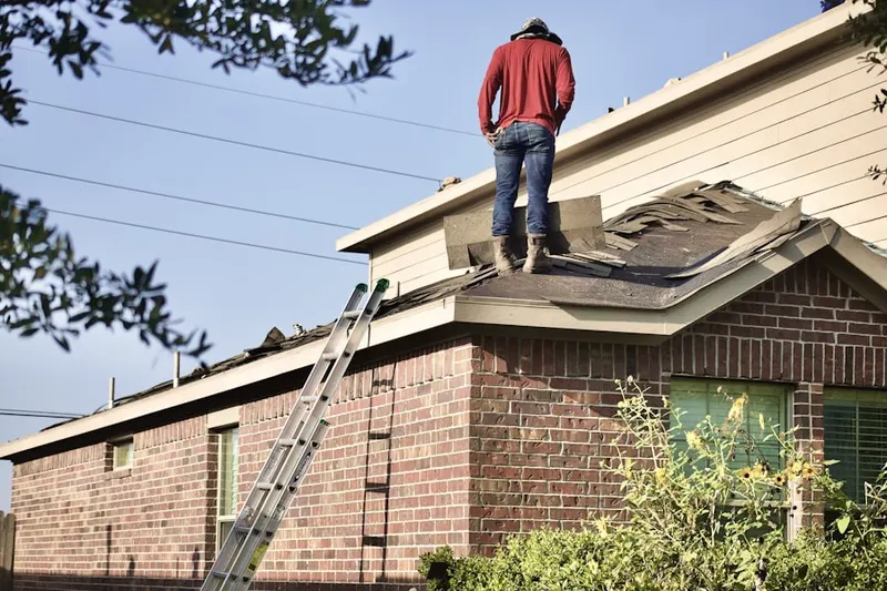 Professional roofer working on a residential roof in Fernbank
